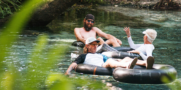 People tubing down a river.