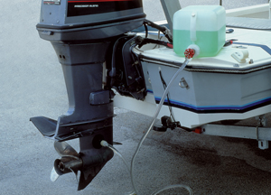 Engine winterizing kit being used on an outboard motor