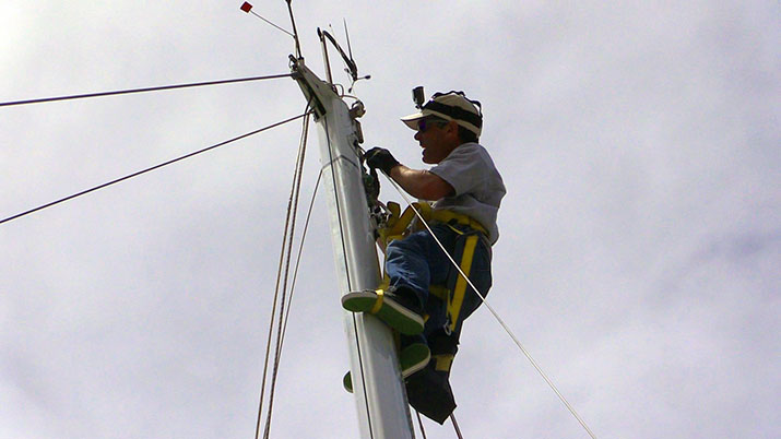 Mark using the mastclimber at the top of the mast