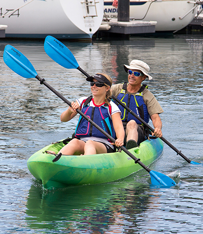 Man and woman paddling tandem kayak