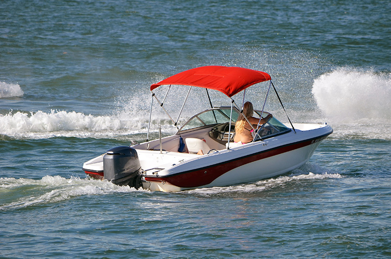 Woman driving a runabout boat