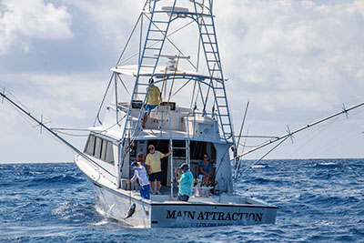 Offshore fishing boat with outriggers deployed