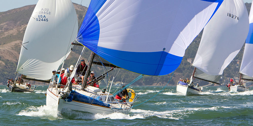 Sailboats in regatta flying spinnakers