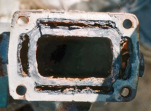 Manifold port water jacket obstructed by rust.