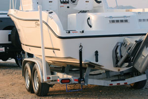 white power boat on a trailer equipped with surge brakes