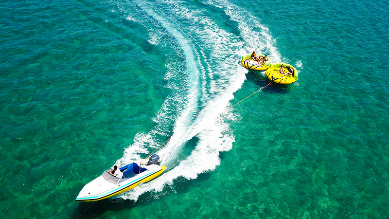Ariel shot of pwerboat pulling two towable tubes