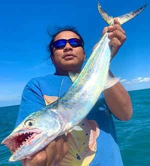 Man holding up large Spanish Mackerel.