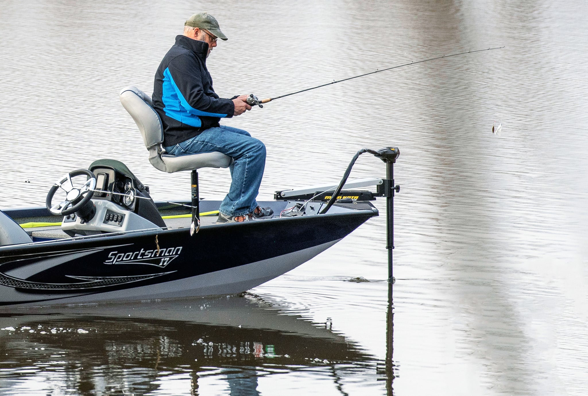 a guy on a fishing boat using a trolling motor