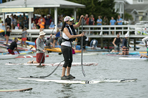 person on a paddlebaord with leash attached