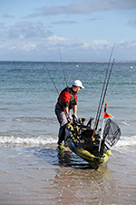 pulling a kayak into the water