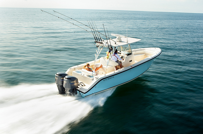 person driving a center console boat