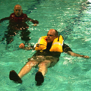 Person testing life vest in the pool at a safety-at-sea seminar