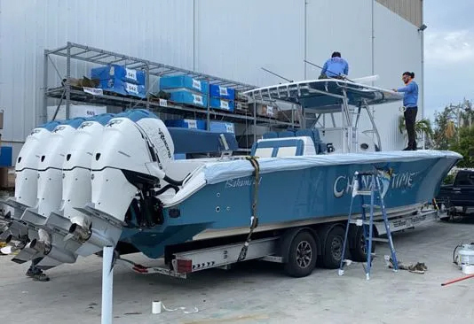 boat being prepared for inland transportation, measuring boat's dimensions, boat transporters gathering accurate information