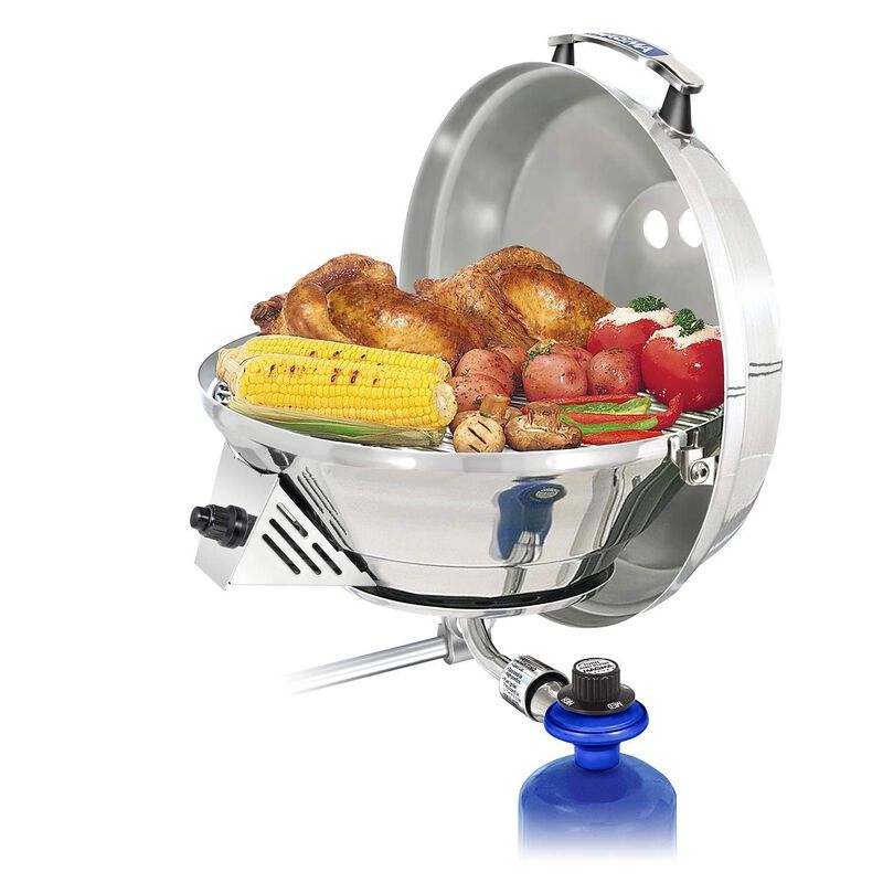 Magma brand round grill with lid open and grilled food displayed