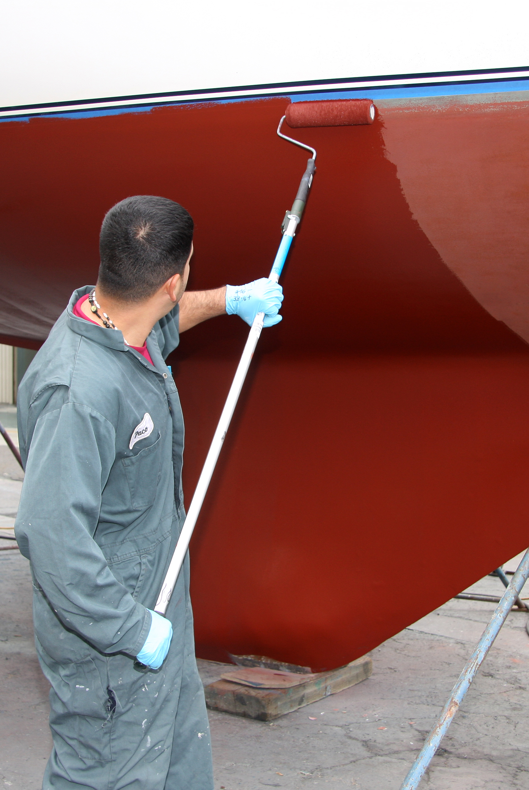 Man painting bottom of boat