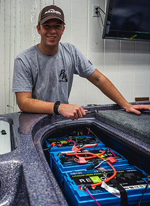 Tournament bass angler next to Relion battery installation