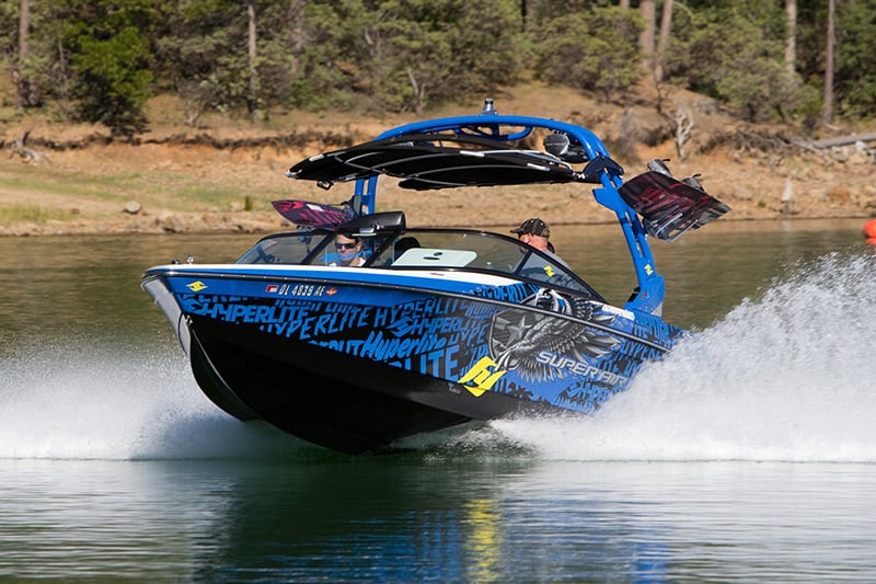 person driving a wake boat