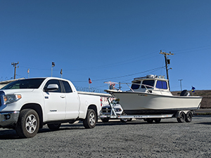 Pickup truck hitched to boat on trailer