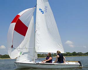 2 Girl Scouts flying a spinnaker on a 420 dinghy