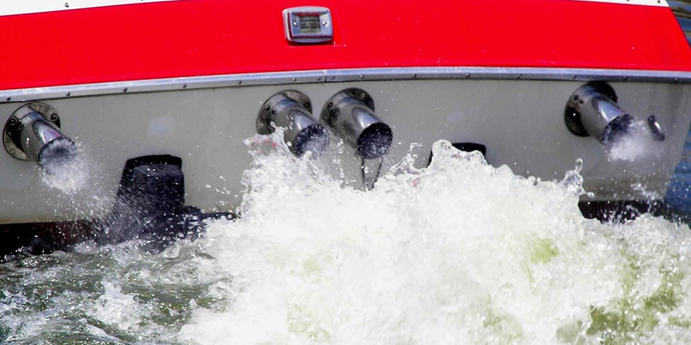 boat exhaust shown through stern wake