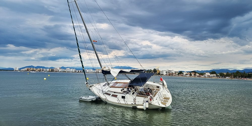 Sailboat run aground, stranded in shallow water