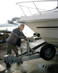 Checking the bow tiedown on a trailered boat