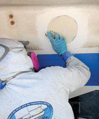 filling a hole in the boat using WEST system epoxy