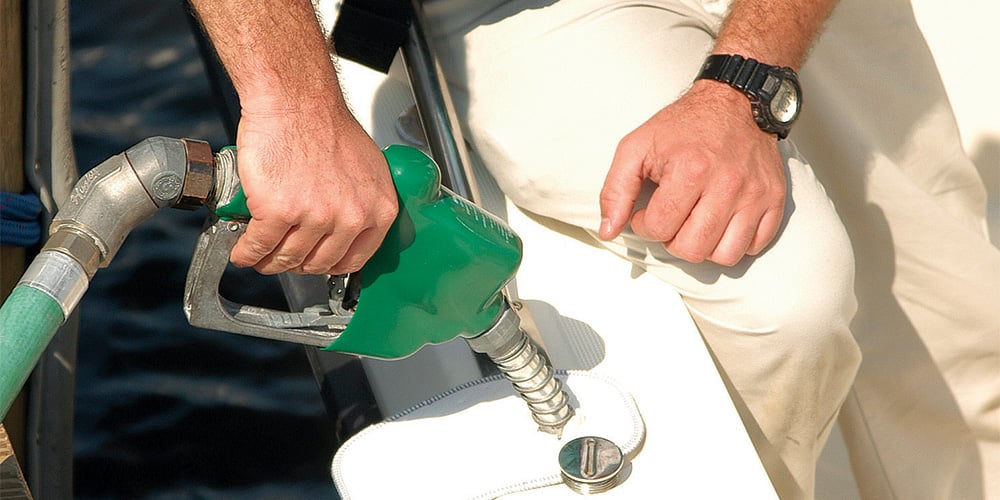Person filling up a boat with fuel
