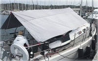 Boom-supported cockpit awning