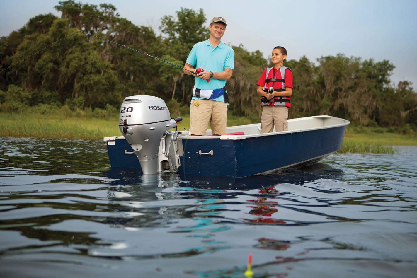 two people on a fishing boat with a 20 horsepower Honda outboard attached