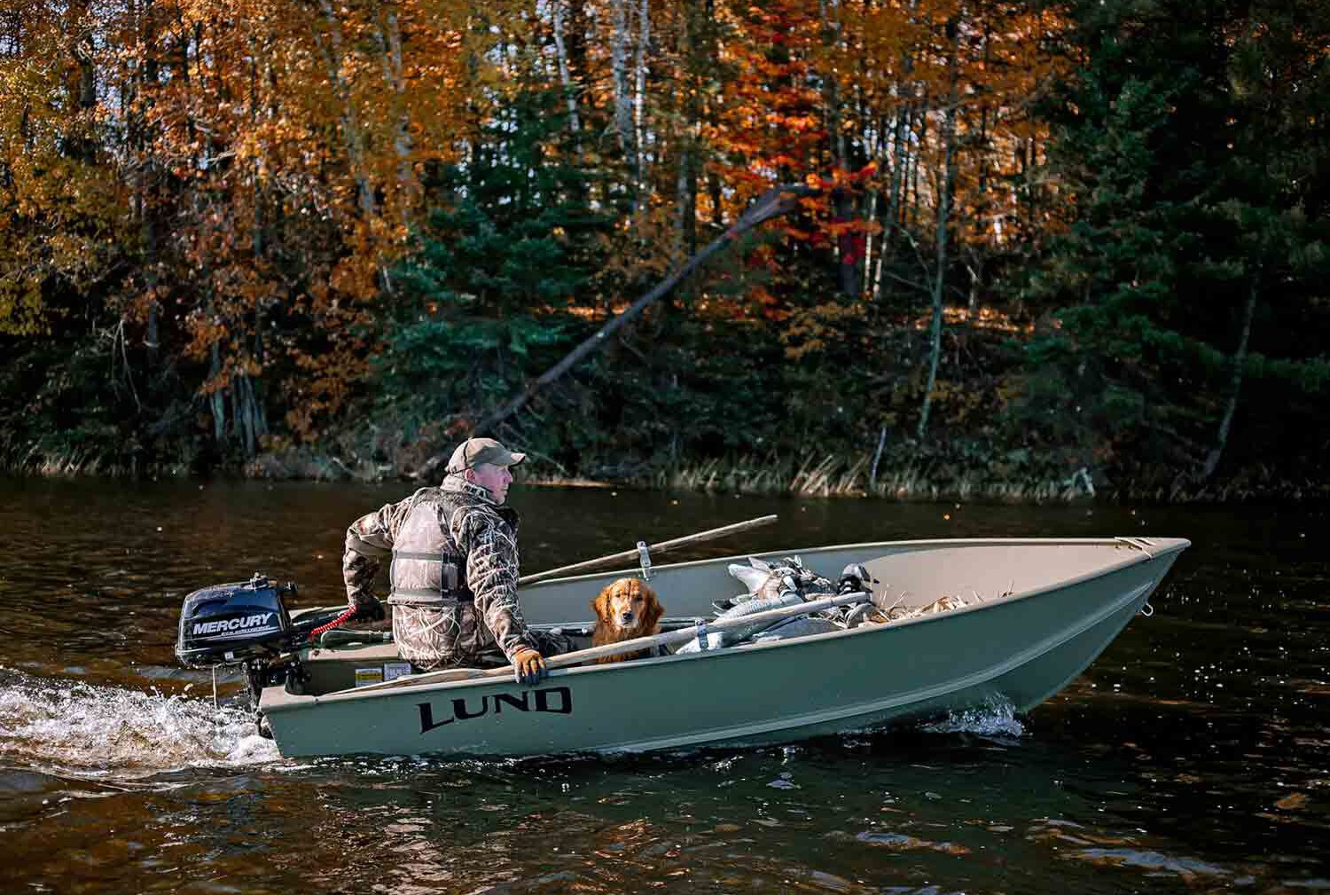small fishing boat moving through the water with a small mercury outboard attached