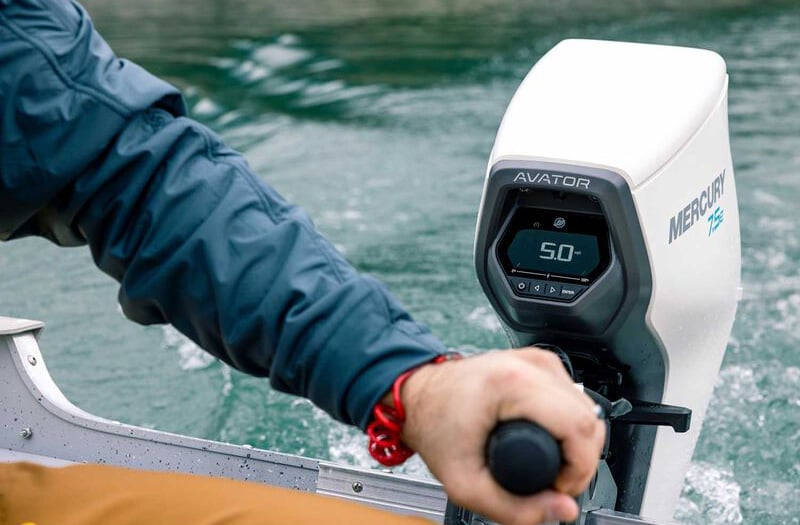 close up of a person's hand on the throttle of an electric outboard