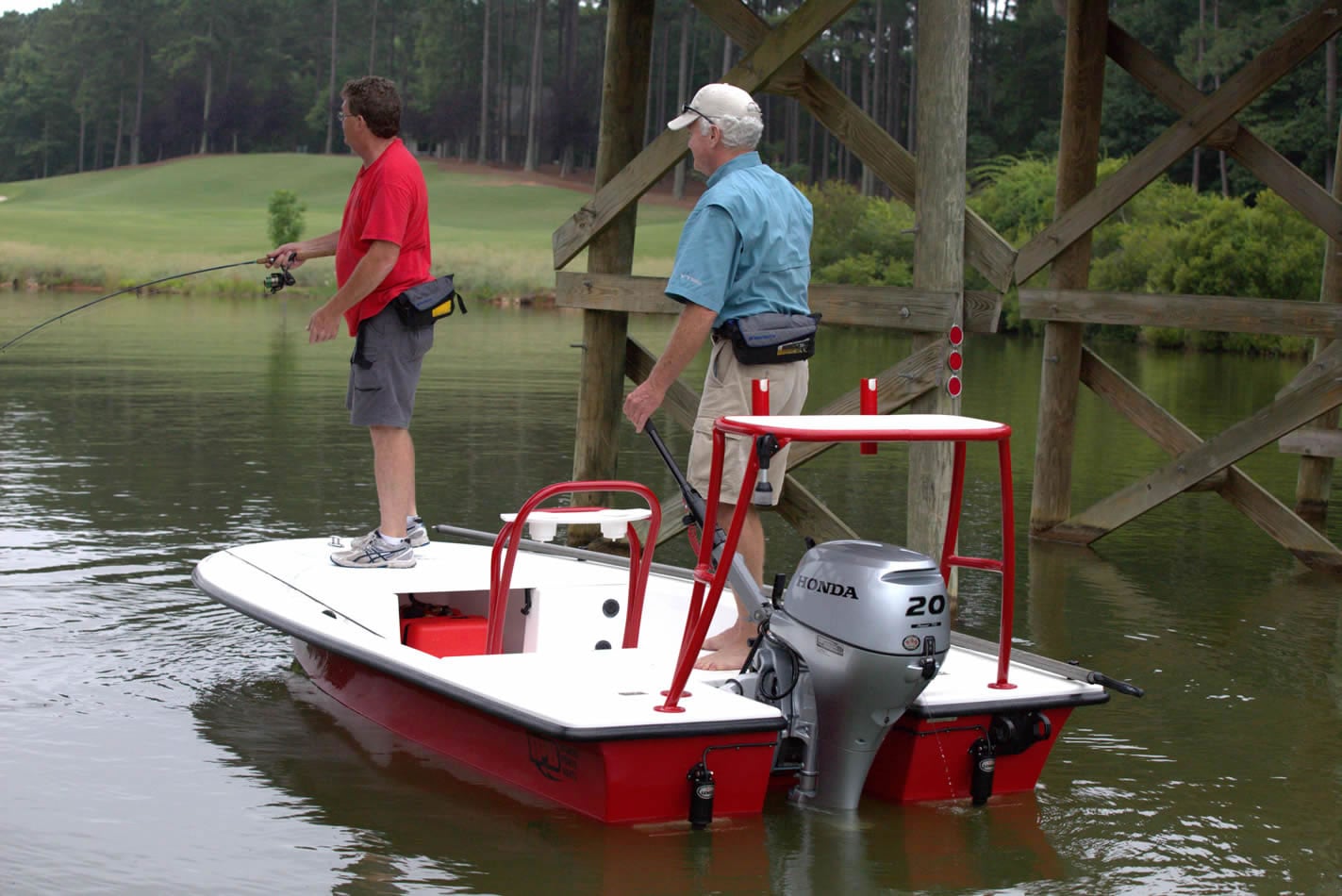 two men on a fishing boat with a 20 horsepower honda outboard motor attached