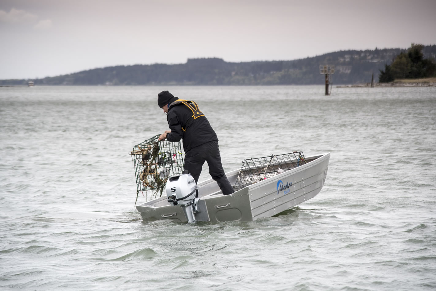 a small crabbing boat with a 5 horsepower honda outboard attached